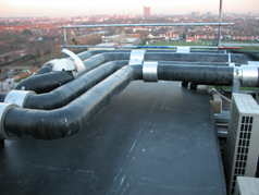 Recently AMC Roofing designed and constructed this new roof over the two ducting risers to the roof of Hammersmith Hospital, in the process overcoming many awkward pipe and cable details penetrating up through the riser.